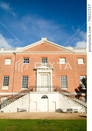 A historic red brick building in a park on the outskirts of London A historic red brick building in a park on the outskirts of London 79031557