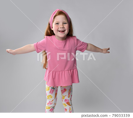 Happy little red-haired girl child widely Happy little red-haired girl child widely 79033339