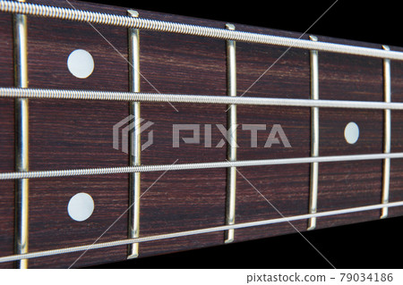 Four string bass guitar fretboard neck with selective focus 79034186