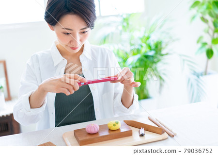 A woman who shoots the Japanese sweets she made with her smartphone A woman who shoots the Japanese sweets she made with her smartphone 79036752