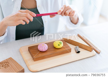 A woman who shoots the Japanese sweets she made with her smartphone A woman who shoots the Japanese sweets she made with her smartphone 79036755