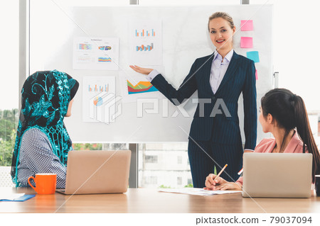 Multicultural working group in teamwork meeting. 79037094
