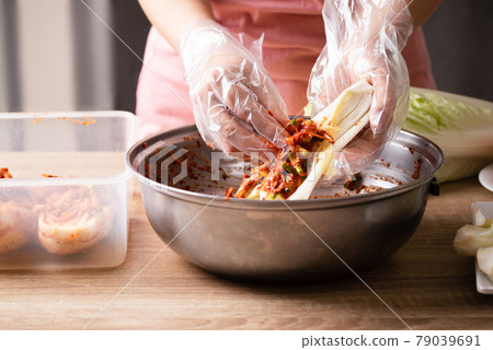 Woman making kimchi cabbage in a big bowl, Popular homemade Korean food 79039691