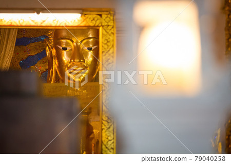 Buddha statue on yellow background Buddha statue on yellow background 79040258