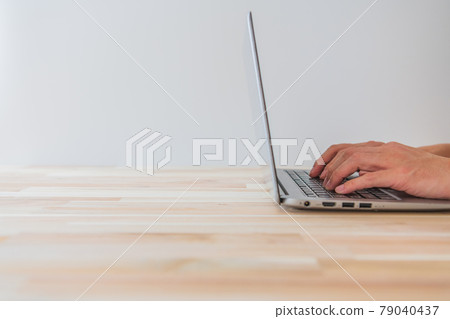 Person operating a laptop White background Horizontal angle material 79040437