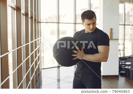 A handsome man is engaged in a gym A handsome man is engaged in a gym 79040863