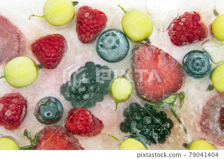 different juicy berries frozen in ice. useful vitamin healthy food 79041404
