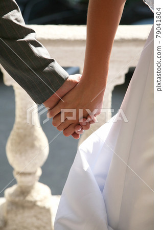 hands of the bride and groom together 79041804