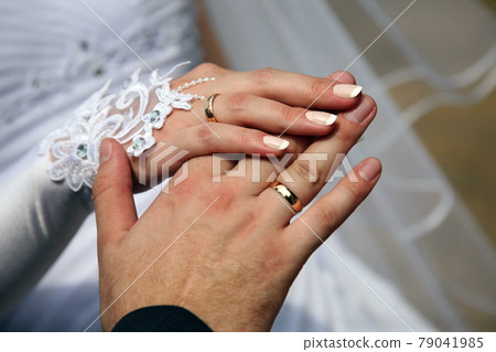 hands of the bride and groom together 79041985