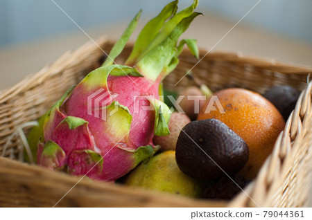 Big basket of fresh tropical fruits, passion fruit, carambola, dragon fruit or pitaya, mangosteen, lichi, granadilla. Exotic fruits, healthy eating concept 79044361