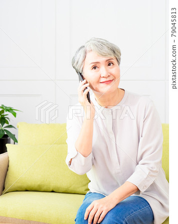 Senior asian woman talking on her mobile phone. Senior woman has a happy conversation at cellphone. Senior asian woman talking on her mobile phone. Senior woman has a happy conversation at cellphone. 79045813