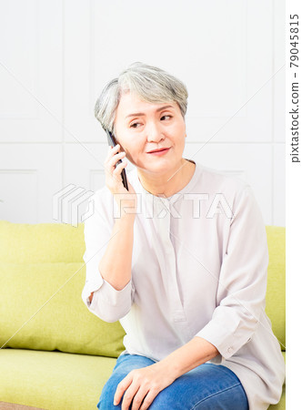 Senior asian woman talking on her mobile phone. Senior woman has a happy conversation at cellphone. 79045815