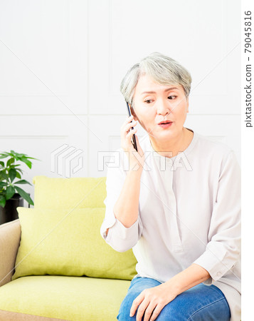 Senior asian woman talking on her mobile phone. Senior woman has a happy conversation at cellphone. Senior asian woman talking on her mobile phone. Senior woman has a happy conversation at cellphone. 79045816