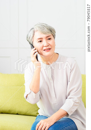 Senior asian woman talking on her mobile phone. Senior woman has a happy conversation at cellphone. Senior asian woman talking on her mobile phone. Senior woman has a happy conversation at cellphone. 79045817