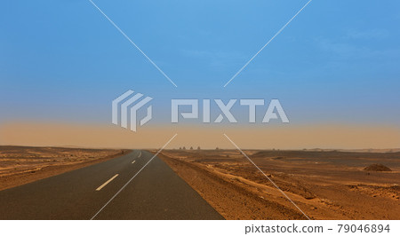 Road through the Sahara with the tombs of old dongola on the horizon Road through the Sahara with the tombs of old dongola on the horizon 79046894