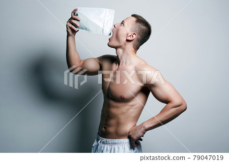 bodybuilder eating sports nutrition. Sport body muscular Man bodybuilder eating sports nutrition. Sport body muscular Man 79047019