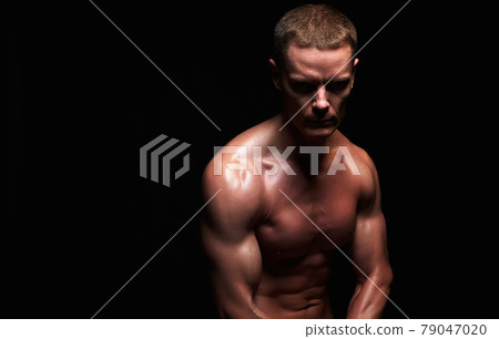 bodybuilder in dark. strong Boy. Naked body muscular Man bodybuilder in dark. strong Boy. Naked body muscular Man 79047020