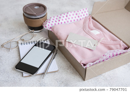 Clothes fir kids in an open cardboard box 79047701