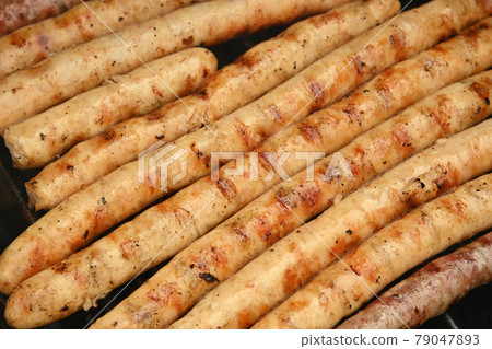 Smoking meat sausages on grill Smoking meat sausages on grill 79047893