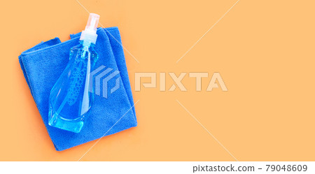 Window cleaner in plastic bottle with blue towel 79048609