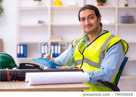 Young male architect working in the office Young male architect working in the office 79050089