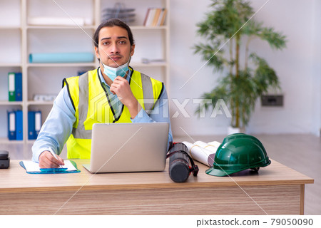 Young male architect working in the office during pandemic Young male architect working in the office during pandemic 79050090