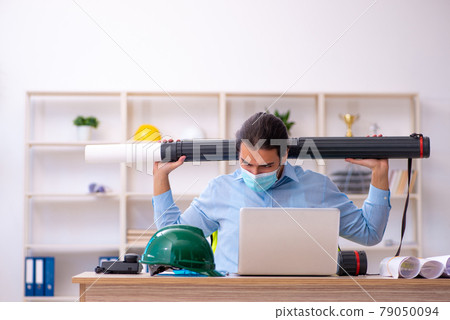 Young male architect working in the office during pandemic Young male architect working in the office during pandemic 79050094