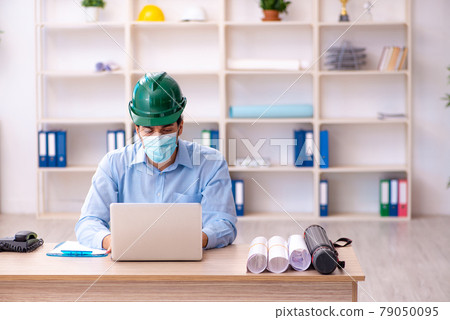 Young male architect working in the office during pandemic Young male architect working in the office during pandemic 79050095