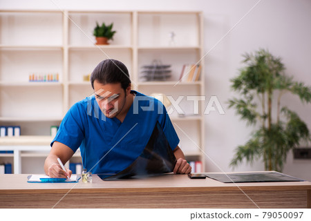 Young male doctor radiologist working in the clinic Young male doctor radiologist working in the clinic 79050097