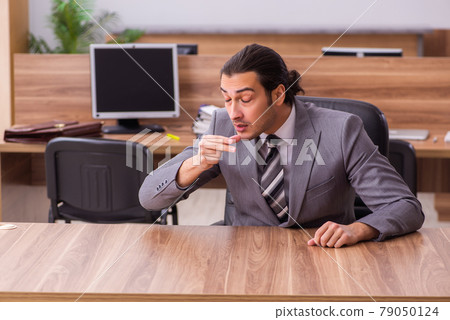 Young businessman employee sitting in the office Young businessman employee sitting in the office 79050124