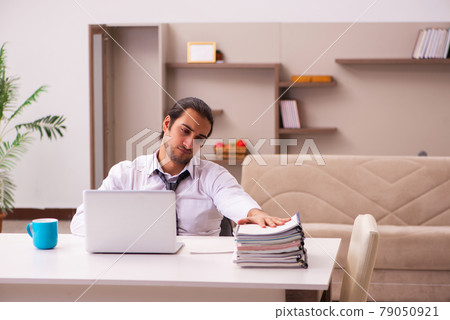 Young male employee working from home during pandemic Young male employee working from home during pandemic 79050921