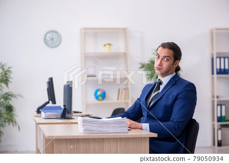 Young male employee working in the office Young male employee working in the office 79050934