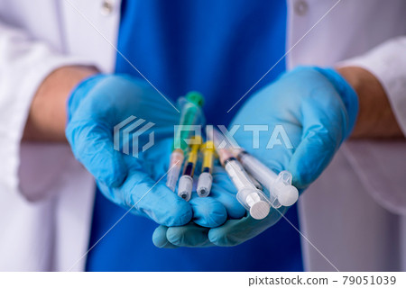 Young male doctor in vaccination concept Young male doctor in vaccination concept 79051039