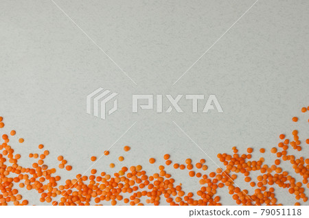 Top view on lentil seeds isolated on a white background.Lentils are rich in vegetable protein and are eaten since prehistoric times.Flat lay with copy space 79051118