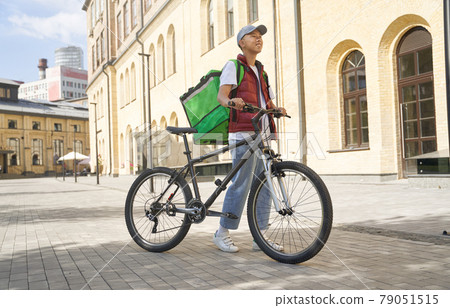 Fresh food from restaurant to your door. Young happy asian male Fresh food from restaurant to your door. Young happy asian male 79051515