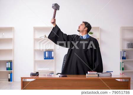 Young male judge working in the courtroom 79051786