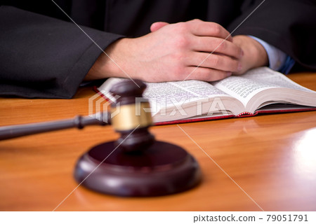 Young male judge working in the courtroom 79051791