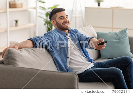 Happy jewish guy spending weekend watching tv Happy jewish guy spending weekend watching tv 79052124