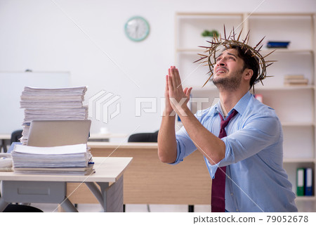 Young male employee wearing prickly wreath on head Young male employee wearing prickly wreath on head 79052678