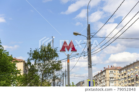 Moscow Metro. A sign above the entrance to the metro station. Red letter M with electric backlight and informational text about the subway, Russia Moscow Metro. A sign above the entrance to the metro station. Red letter M with electric backlight and informational text about the subway, Russia 79052848