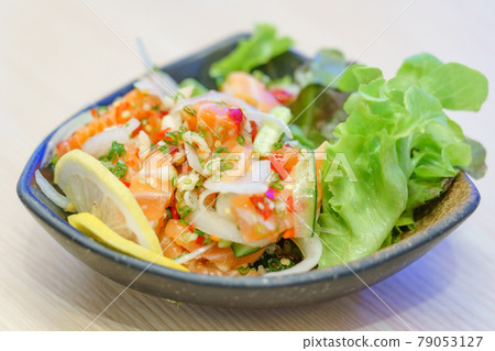 Salmon sashimi in spicy hot sauce. Mix Japanese and Thai food between Japan salmon sashimi and Thai herb in Japanese restaurant. Salmon sashimi in spicy hot sauce. Mix Japanese and Thai food between Japan salmon sashimi and Thai herb in Japanese restaurant. 79053127