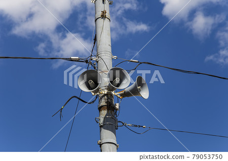 Megaphone speaker (reproducer) on the pole lighting against the sky with clouds. Moscow, Russia Megaphone speaker (reproducer) on the pole lighting against the sky with clouds. Moscow, Russia 79053750