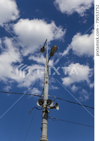 Megaphone speaker (reproducer) on the pole lighting against the sky with clouds. Moscow, Russia Megaphone speaker (reproducer) on the pole lighting against the sky with clouds. Moscow, Russia 79053752
