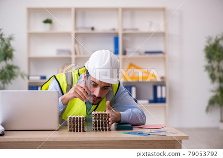 Young male architect suffering at workplace 79053792