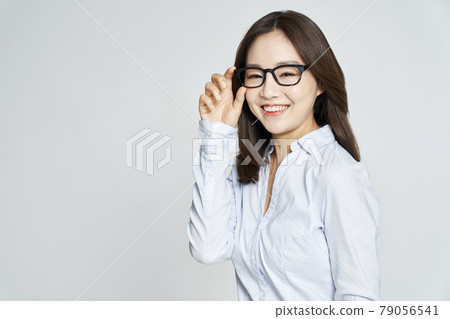 glasses, ophthalmology, young woman, business woman, career woman, nude, gray background glasses, ophthalmology, young woman, business woman, career woman, nude, gray background 79056541