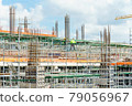 Modern building is under construction, metal scaffolding and blue sky 79056967