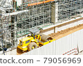 Modern building is under construction, metal scaffolding and blue sky 79056969