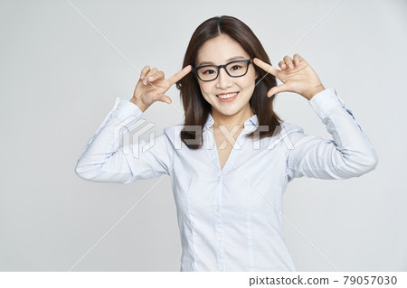 glasses, ophthalmology, young woman, business woman, career woman, nude, gray background glasses, ophthalmology, young woman, business woman, career woman, nude, gray background 79057030