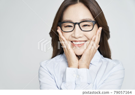 glasses, ophthalmology, young woman, business woman, career woman, nude, gray background glasses, ophthalmology, young woman, business woman, career woman, nude, gray background 79057164