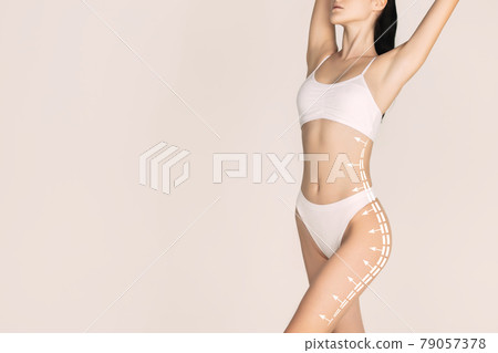 Cropped slim female body in white underwear isolated over light background. 79057378